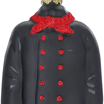 Weihnachtsbaumornament in Form einer schwarzen Kochjacke mit rot-glitzerndem Tuch und Knöpfen